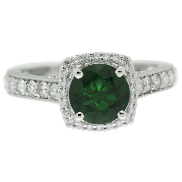 Round emerald with a cushion diamond halo ring